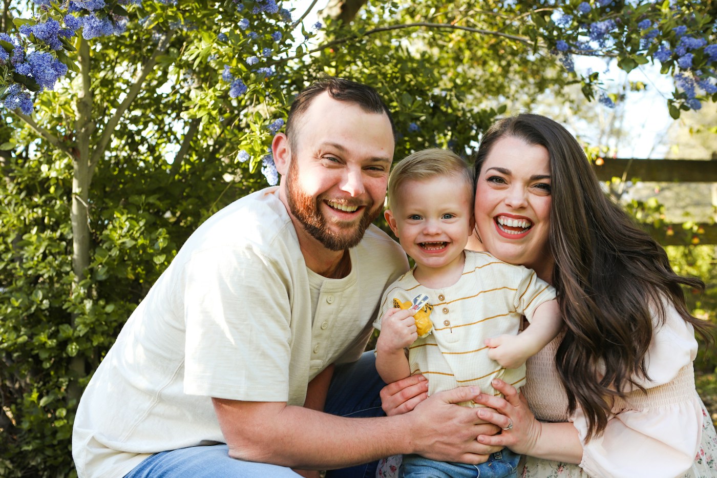 Parents enjoying a moment outdoors with their young child